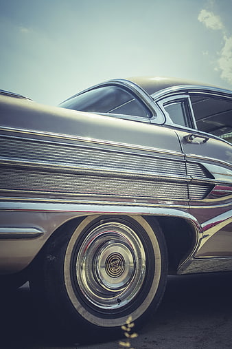 Close-up of vintage classic car wheel and chrome details