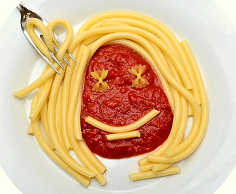 Creative pasta art face made with spaghetti and tomato sauce