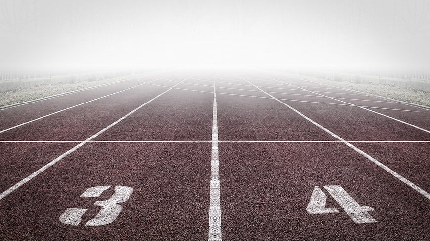 Empty Running Track with Fog and Lane Numbers