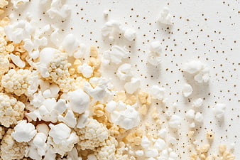 Popcorn and kernels on white background