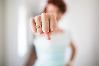Woman showing gold ring with empowering inscription