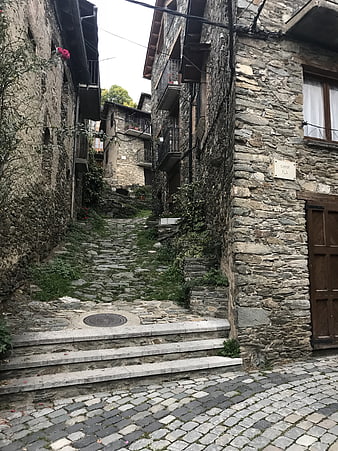 Narrow cobblestone street in historic stone village