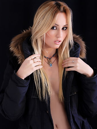 Sensual Studio Portrait Of A Blonde Woman In A Black Fur Jacket