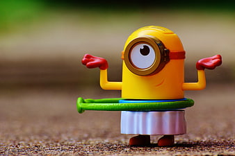 Cute yellow Minion toy hula hooping outdoors