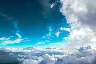 Aerial View of Fluffy White Clouds Against Vibrant Blue Sky