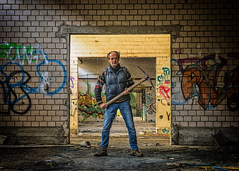 Man with Pickaxe in Abandoned Graffiti Building