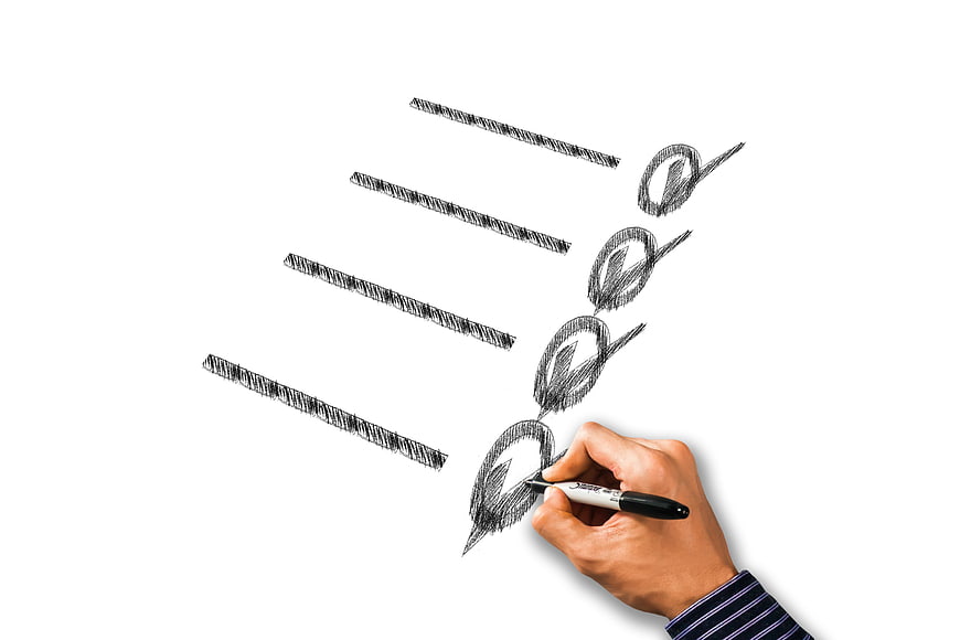Hand sketching checklist with marker on white background