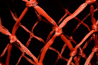 Close-up of orange basketball net on black background