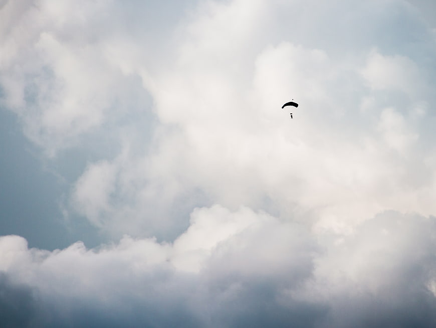 Parachutist Silhouette Against Dramatic Cloudy Sky