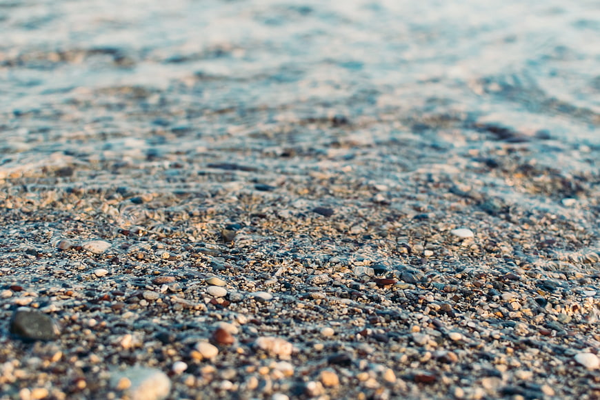 Close-up of wet pebbles on a beach shoreline