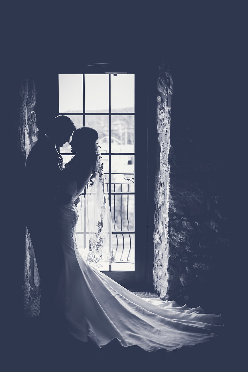 Silhouette of Bride and Groom in Front of Window