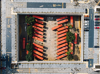 Aerial view of orange buses parked in a depot