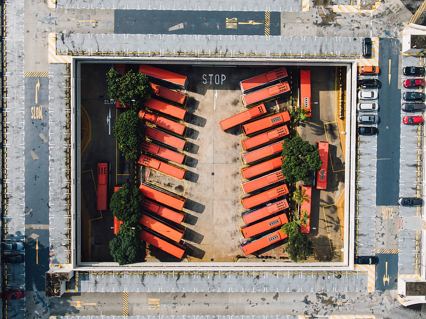Aerial view of orange buses parked in a depot