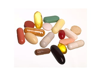 Assorted Medication Pills And Capsules On White Background