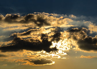 Dramatic sunset clouds with golden sunlight breaking through