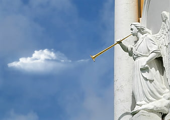White Angel Statue Blowing Golden Trumpet Against Blue Sky