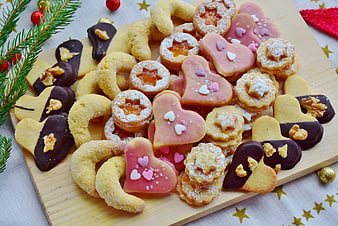 Assorted Christmas Cookies on Wooden Board with Pine Sprigs