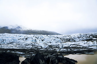 Dramatic Glacier Landscape with Cracked Ice and Misty Mountains