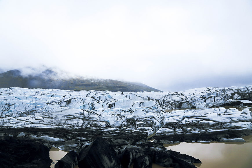 Dramatic Glacier Landscape with Cracked Ice and Misty Mountains