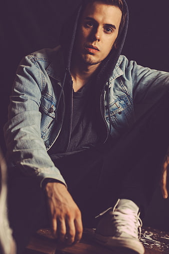 Moody Portrait of Young Man in Denim Jacket and Hoodie