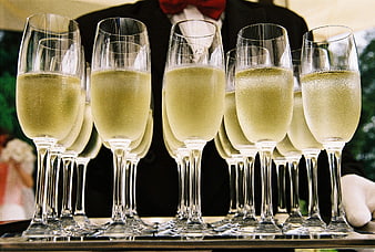 Champagne Flutes on Silver Tray with Butler in Background