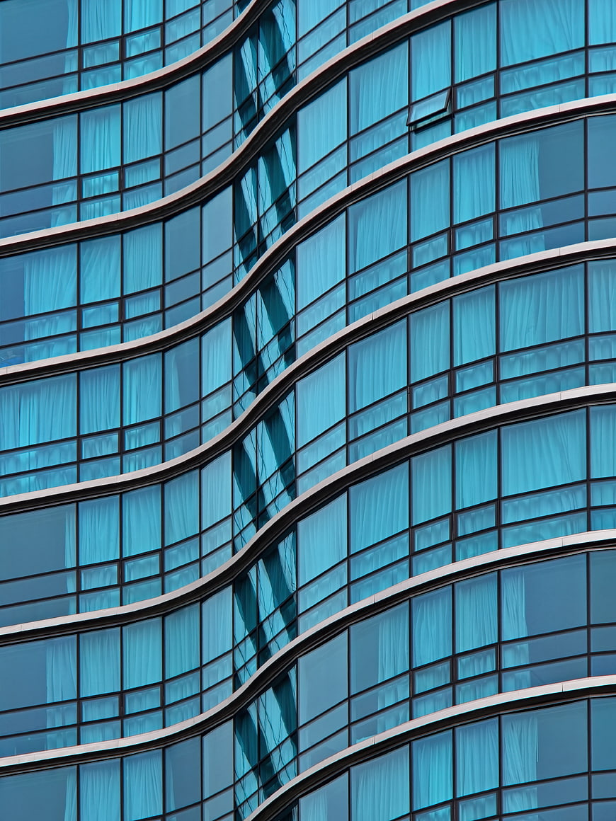 Abstract Blue Curved Glass Office Building Facade