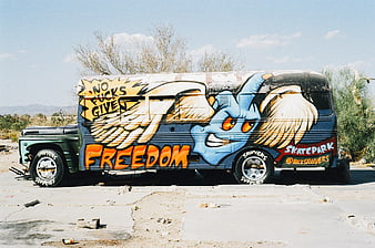 Graffiti Van with Middle Finger and Wings in Desert