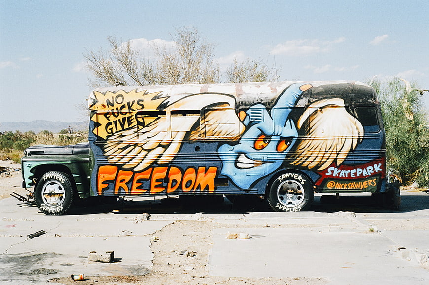 Graffiti Van with Middle Finger and Wings in Desert