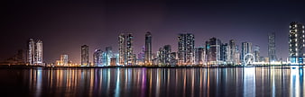 Panoramic Night Skyline of Modern City with Water Reflections