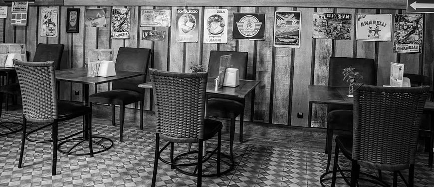 Black and white interior of a vintage restaurant with wooden walls