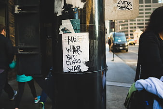 No War But Class War Protest Sign on City Street Pole