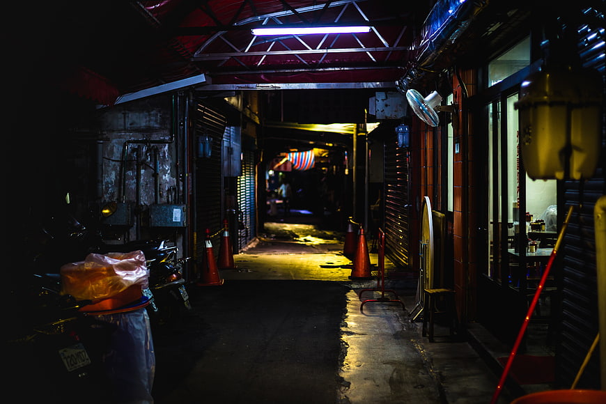 Atmospheric Night Alley with Neon Lights and Wet Pavement
