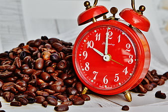 Red Alarm Clock Surrounded by Coffee Beans