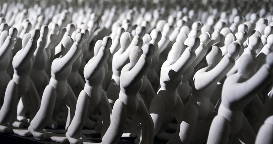 Rows of white clay figurines in a synchronized marching pose