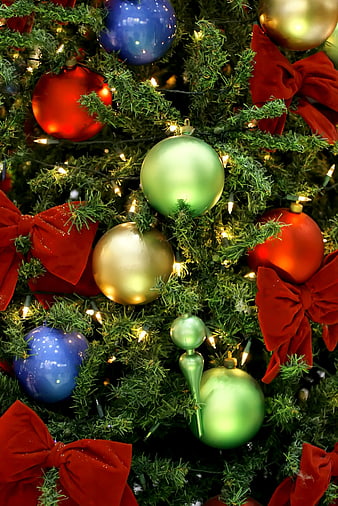 Close-up of Christmas tree with red bows and ornaments