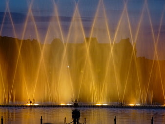 Illuminated fountain jets at dusk in Lunéville