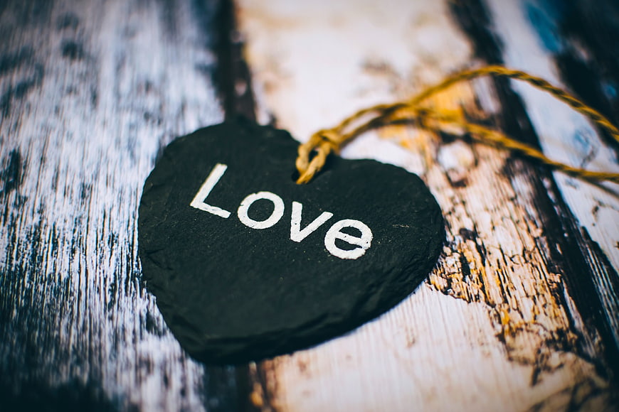 Heart-shaped slate tag with 'Love' on rustic wood