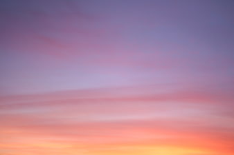 Soft pastel sunset sky with pink and purple clouds