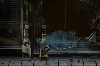 Broken Beer Bottles on Windowsill with Shattered Glass