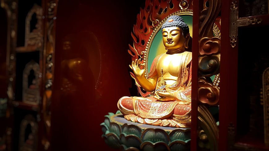 Golden Buddha Statue in Red Temple Niche