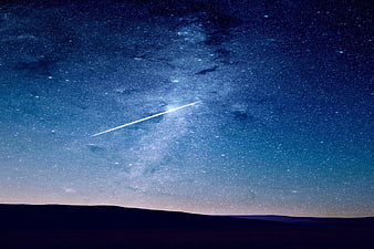 Shooting Star Streaking Across Milky Way Night Sky
