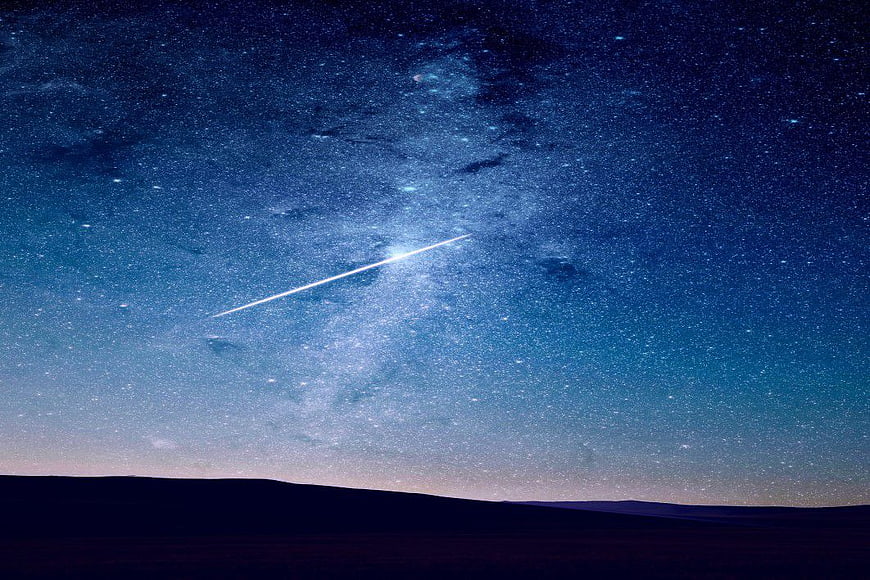 Shooting Star Streaking Across Milky Way Night Sky