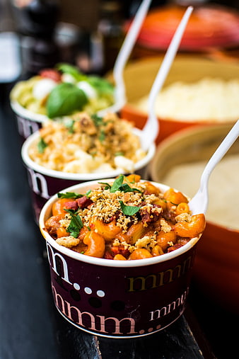 Close-up of Italian pasta dishes in takeaway cups