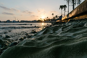 Low Angle Sunset View of Sandy Beach and Coastal Promenade