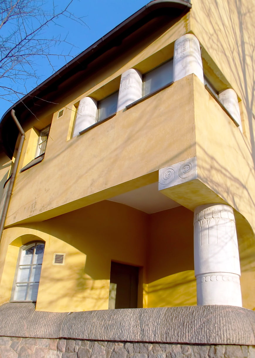 Yellow Art Nouveau Building Facade with White Pillars