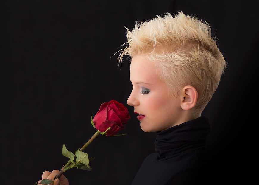 Profile Portrait of Blonde Child Smelling Red Rose