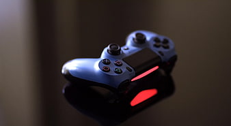 Blue PlayStation 4 Controller on Dark Surface