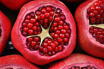 Close-up of Fresh Sliced Pomegranate with Red Arils