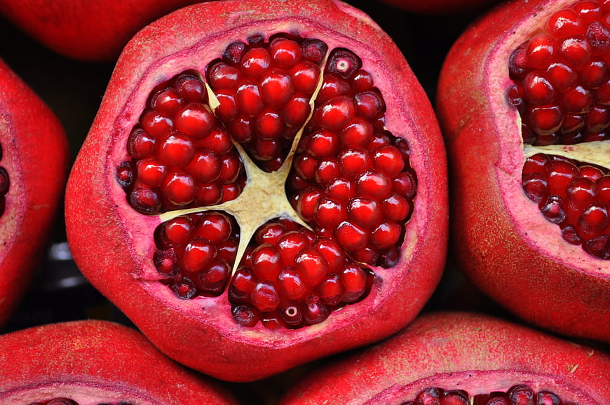 Close-up of Fresh Sliced Pomegranate with Red Arils