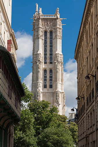 Gothic Cathedral Tower in Paris Between Buildings